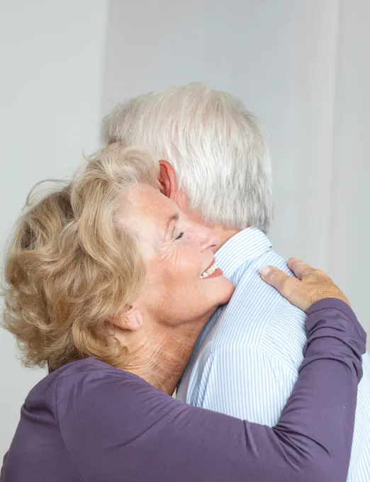 Elderly couple embracing with warmth and love